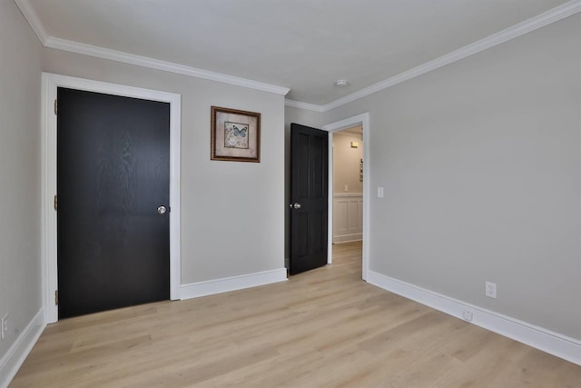 unfurnished bedroom with baseboards, light wood-style flooring, and crown molding