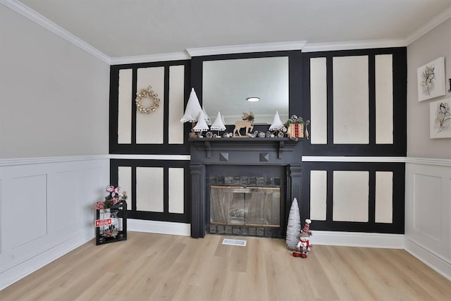 bar featuring wood finished floors, visible vents, ornamental molding, a glass covered fireplace, and a decorative wall