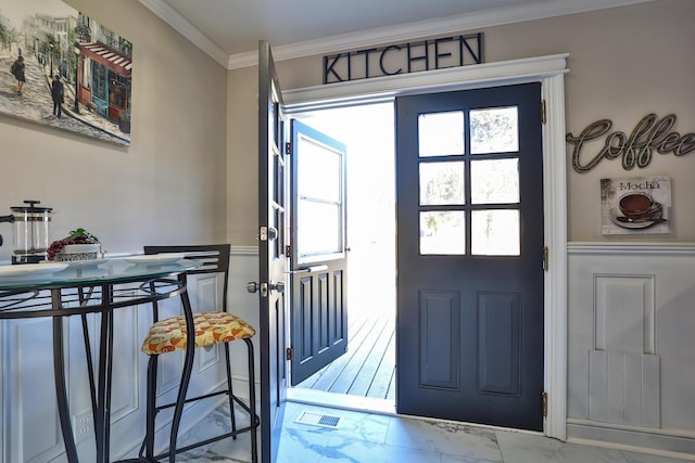 entryway featuring a healthy amount of sunlight, visible vents, and ornamental molding