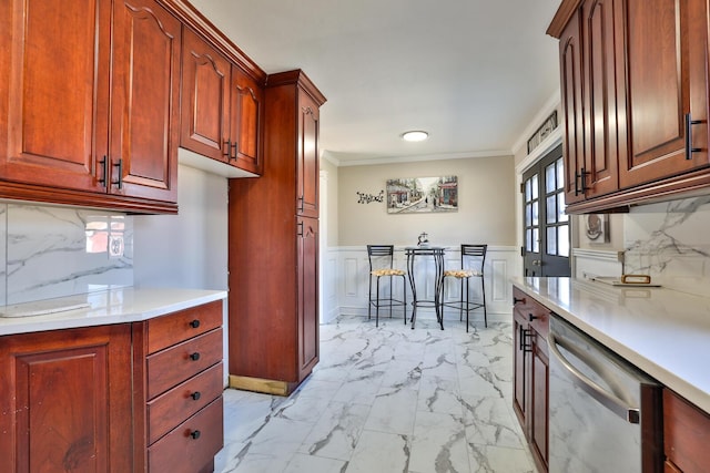 kitchen with crown molding, dishwasher, light countertops, wainscoting, and marble finish floor