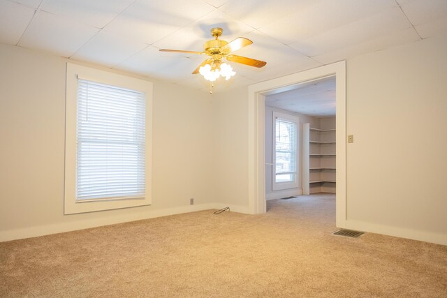 carpeted empty room featuring ceiling fan