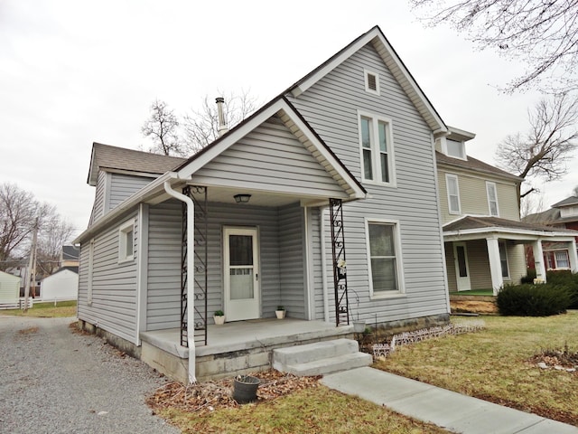 view of front of home with a porch and a front yard