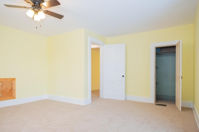 unfurnished bedroom featuring ceiling fan and light colored carpet