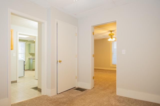 hallway with light colored carpet