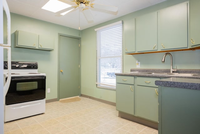 kitchen featuring sink, a skylight, electric range oven, green cabinets, and ceiling fan