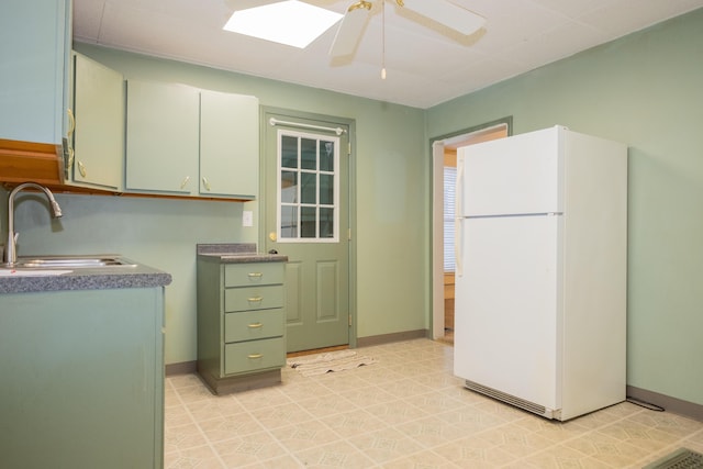 kitchen with white fridge, sink, and ceiling fan