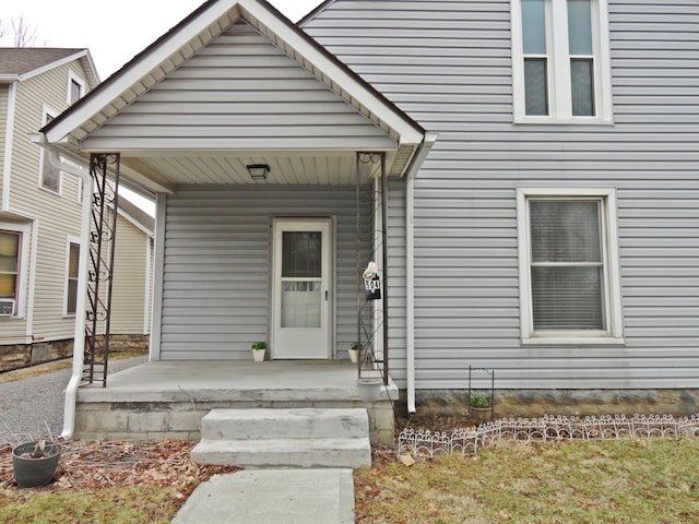 view of exterior entry featuring covered porch