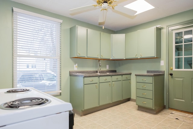 kitchen featuring white electric stove, sink, green cabinets, and ceiling fan