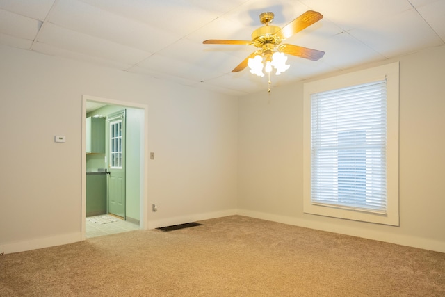 unfurnished room featuring light colored carpet and ceiling fan