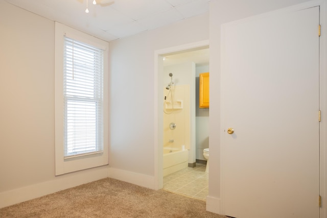 unfurnished room featuring light carpet and ceiling fan