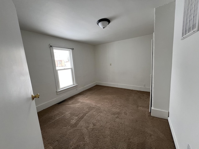 empty room featuring dark colored carpet