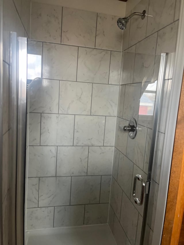 full bath featuring a shower stall