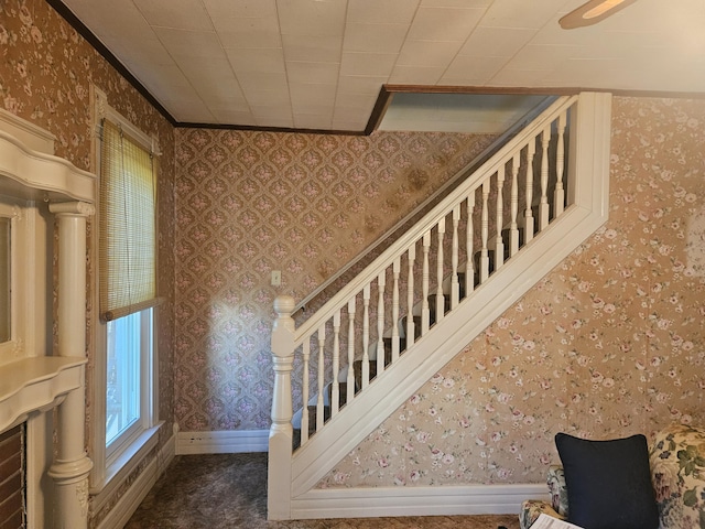 stairway with baseboards, carpet flooring, and wallpapered walls