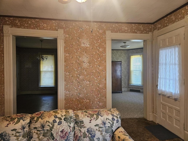 carpeted bedroom with wallpapered walls and baseboards