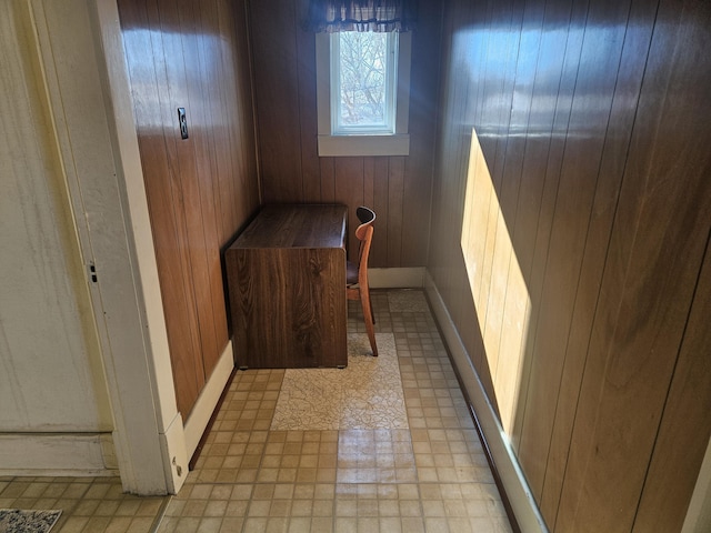 interior space with wooden walls and light floors