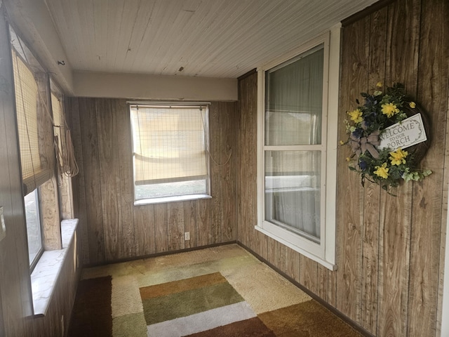 unfurnished sunroom featuring wood ceiling