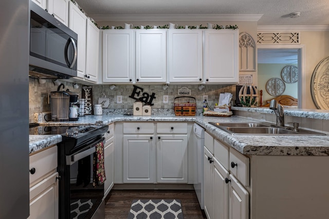 kitchen featuring ornamental molding, white cabinets, black range with electric cooktop, and a sink