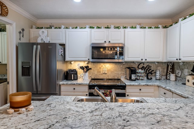 kitchen featuring stainless steel appliances, backsplash, white cabinets, and ornamental molding