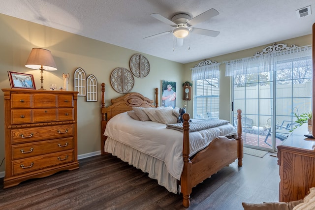 bedroom featuring visible vents, dark wood-type flooring, access to exterior, and a textured ceiling