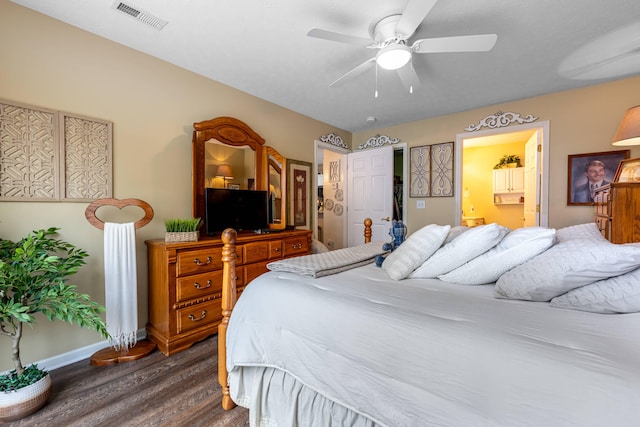 bedroom with visible vents, baseboards, ceiling fan, ensuite bathroom, and dark wood-style floors