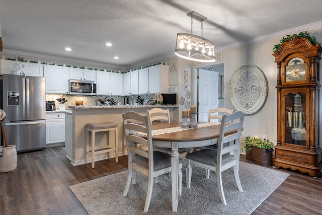 dining space with recessed lighting, a textured ceiling, crown molding, and dark wood-style flooring