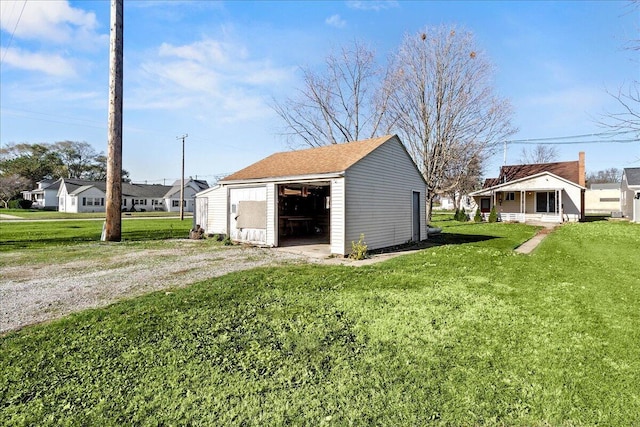 view of outdoor structure featuring a porch and a yard