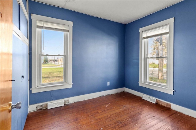 empty room with dark hardwood / wood-style floors