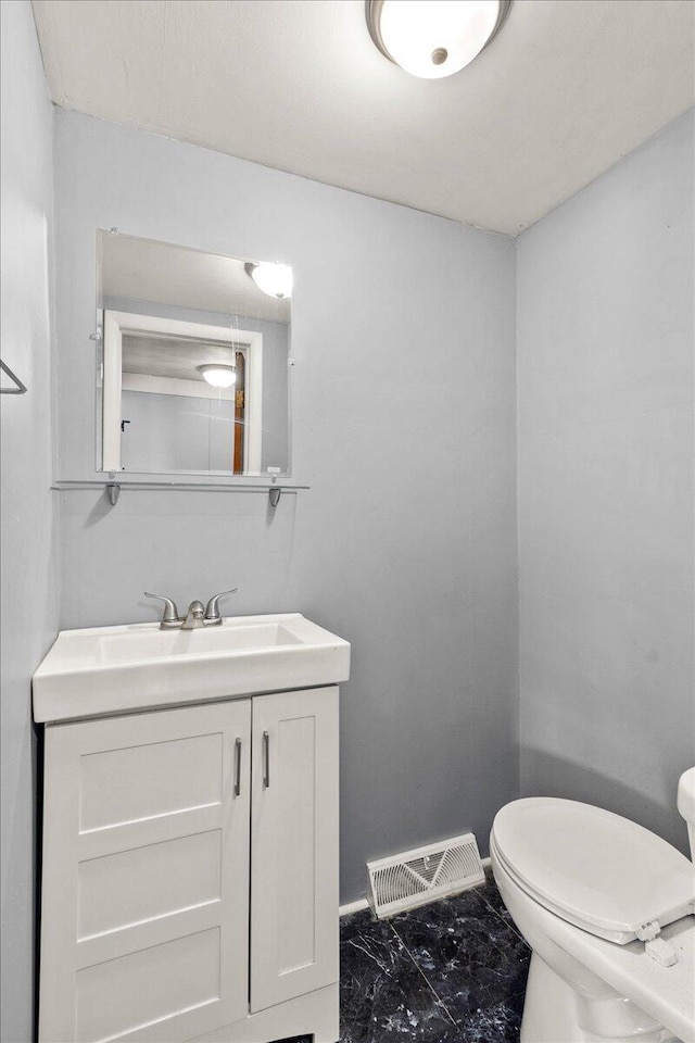 bathroom featuring vanity and toilet