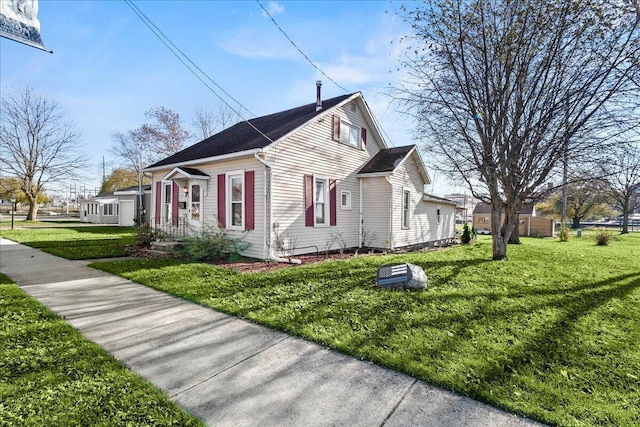 view of side of home with a yard