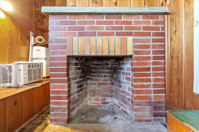 room details with a brick fireplace and wood walls