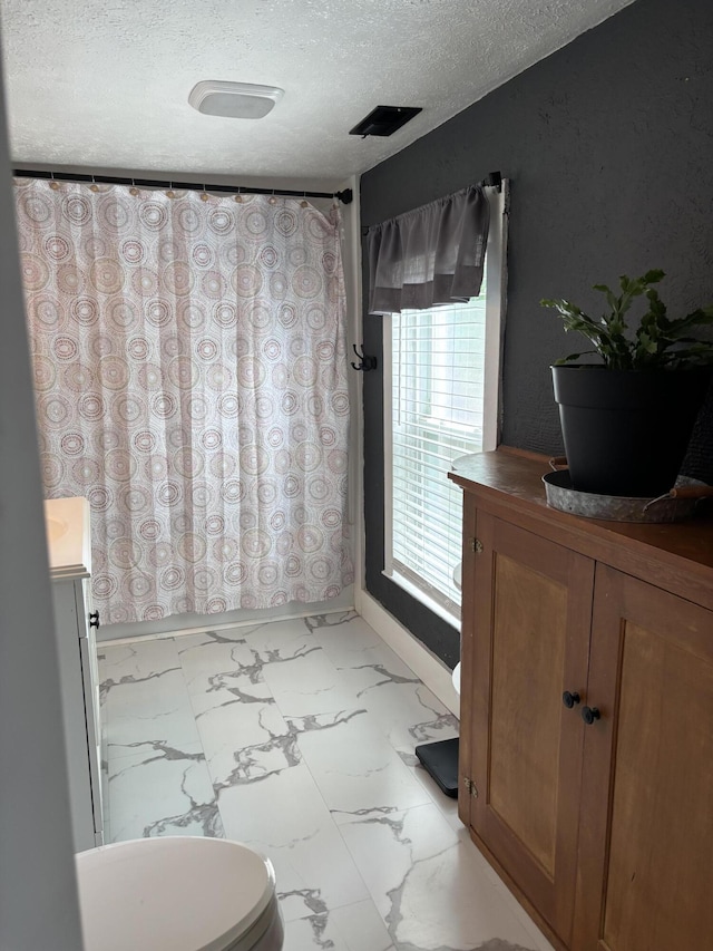 23 E Columbus Rd, South Charleston, OH 45368 - full bathroom featuring vanity, a textured ceiling, and marble finish floors