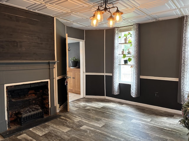 23 E Columbus Rd, South Charleston, OH 45368 - unfurnished living room with an ornate ceiling, wood finished floors, a chandelier, and a fireplace