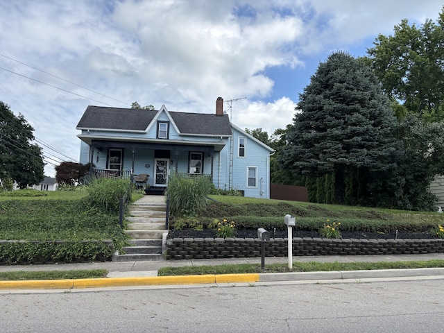 23 E Columbus Rd, South Charleston, OH 45368 - bungalow-style home featuring covered porch, a chimney, and stairs