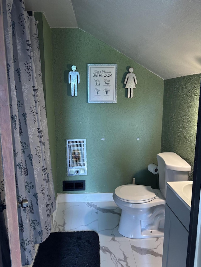 23 E Columbus Rd, South Charleston, OH 45368 - bathroom featuring a textured wall, marble finish floors, vaulted ceiling, vanity, and heating unit