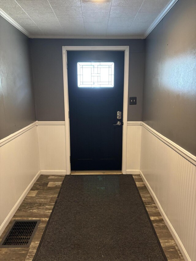23 E Columbus Rd, South Charleston, OH 45368 - doorway with dark wood-style flooring, wainscoting, and crown molding