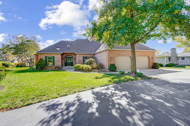 view of front of property with a garage and a front lawn