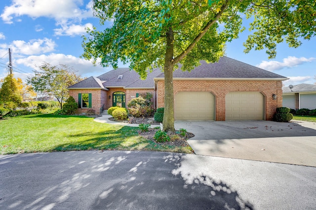 view of front of house featuring a garage and a front lawn