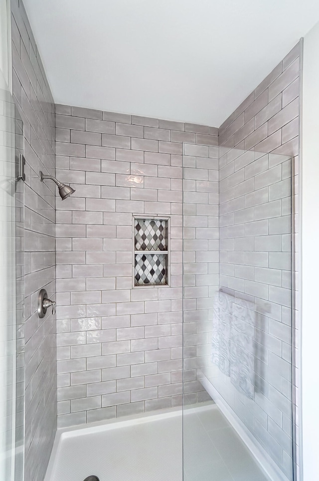 bathroom with a tile shower