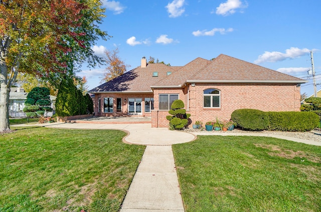 rear view of property featuring a yard and a patio area