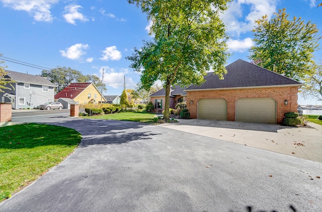 exterior space featuring a garage and a front yard