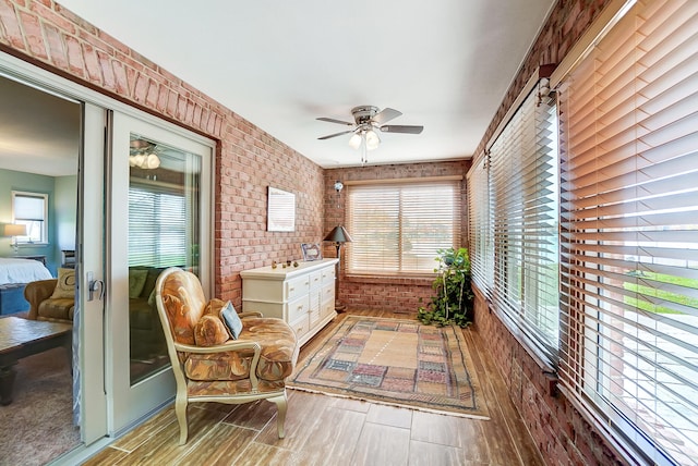 sunroom / solarium featuring ceiling fan