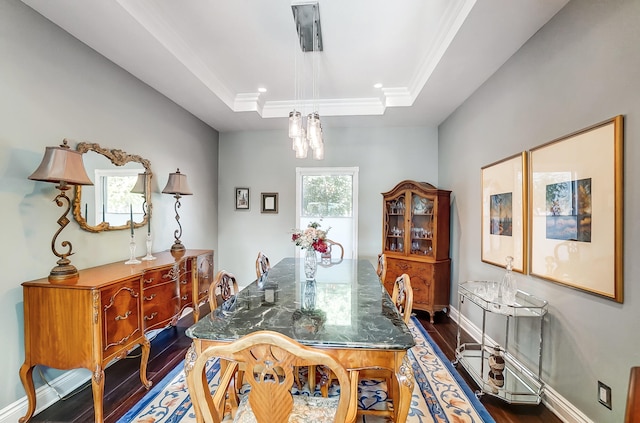 dining area featuring crown molding, dark hardwood / wood-style floors, and a tray ceiling