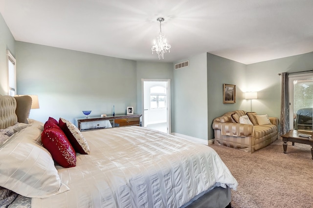 bedroom featuring carpet flooring and a notable chandelier