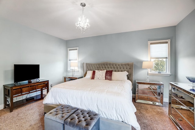 carpeted bedroom featuring an inviting chandelier