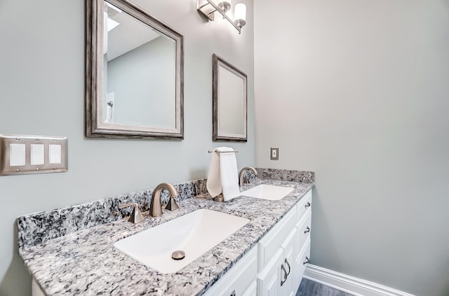 bathroom with vanity and hardwood / wood-style flooring