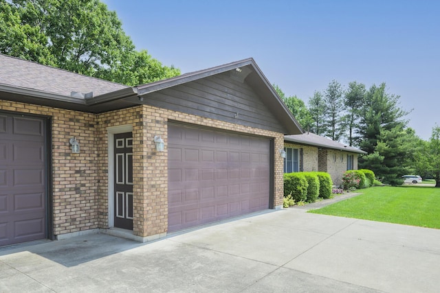 20 Snider Rd, New Carlisle, OH 45344 - view of side of home featuring a garage, brick siding, a yard, and concrete driveway