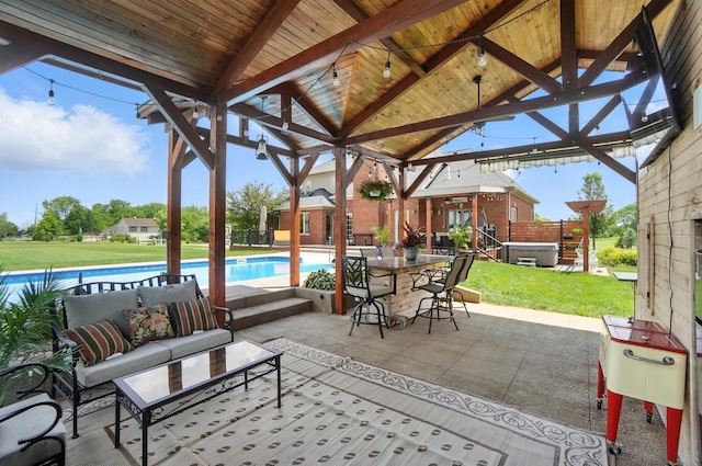 891 N Tecumseh Rd, Springfield, OH 45504 - view of patio featuring a hot tub, an outdoor pool, a gazebo, and an outdoor hangout area