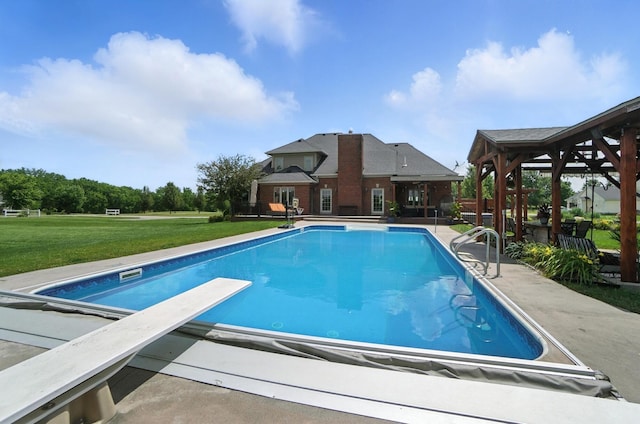 891 N Tecumseh Rd, Springfield, OH 45504 - outdoor pool featuring a lawn, a diving board, and a patio area