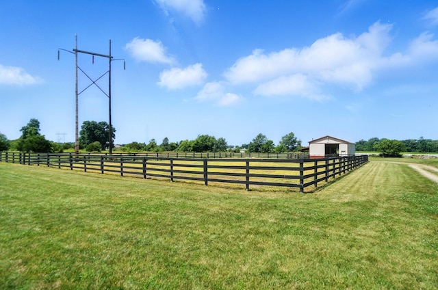891 N Tecumseh Rd, Springfield, OH 45504 - view of grassy yard with a rural view, an outbuilding, an outdoor riding arena, and an exterior structure