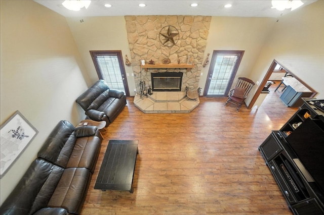 891 N Tecumseh Rd, Springfield, OH 45504 - living area featuring healthy amount of natural light, wood finished floors, a stone fireplace, recessed lighting, and ceiling fan